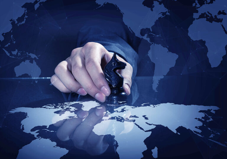 Hand of businessman on dark background making chess move
